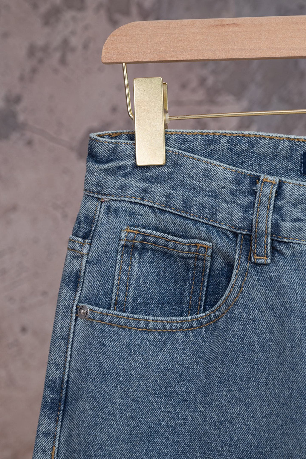 Light blue denim pants back pocket with stitching and waistband button