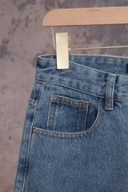 Light blue denim pants back pocket with stitching and waistband button