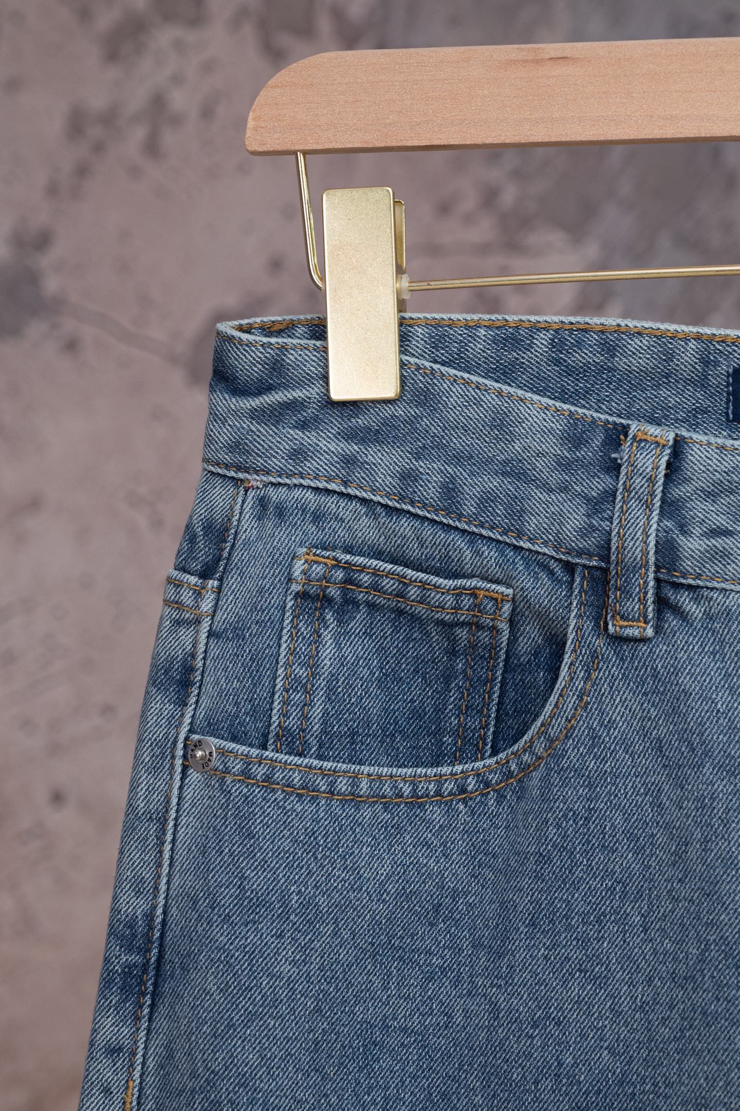 Light blue denim pants back pocket with stitching and waistband button