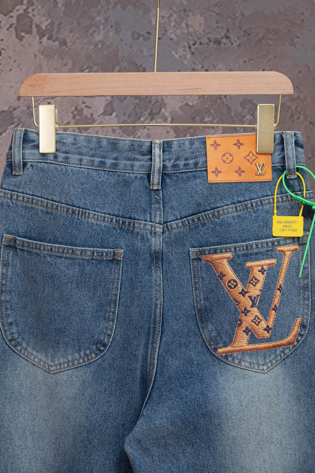 Light blue denim jeans with front patch and large LV monogram on pocket