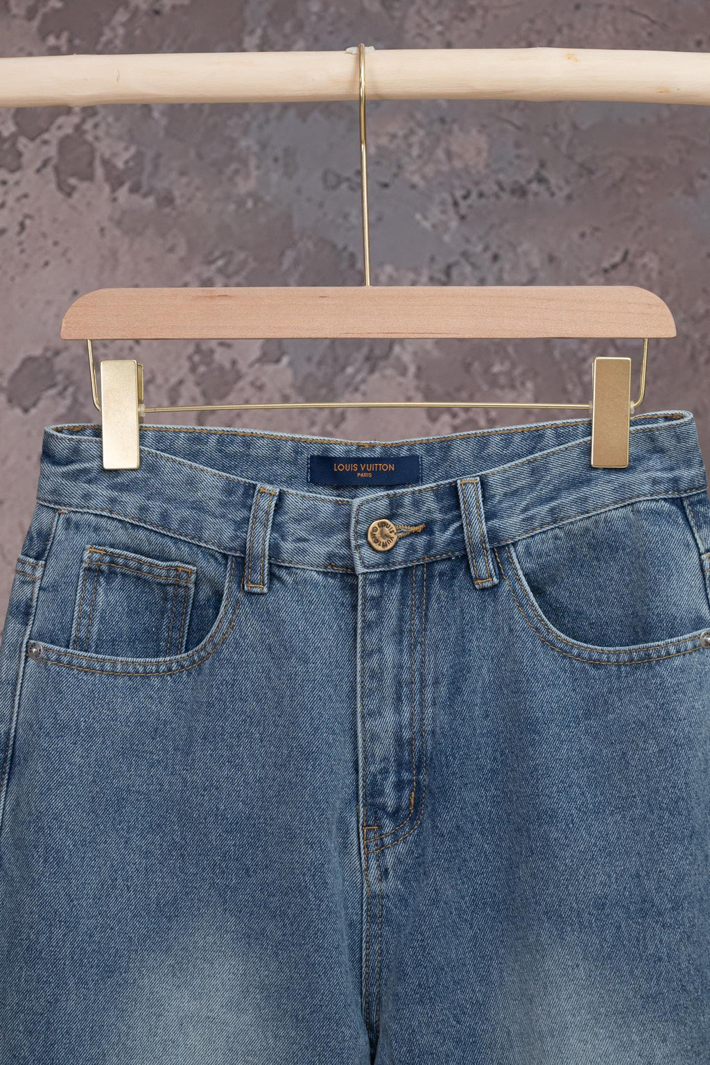 Light blue denim jeans with belt loops, front button, and dual front pockets