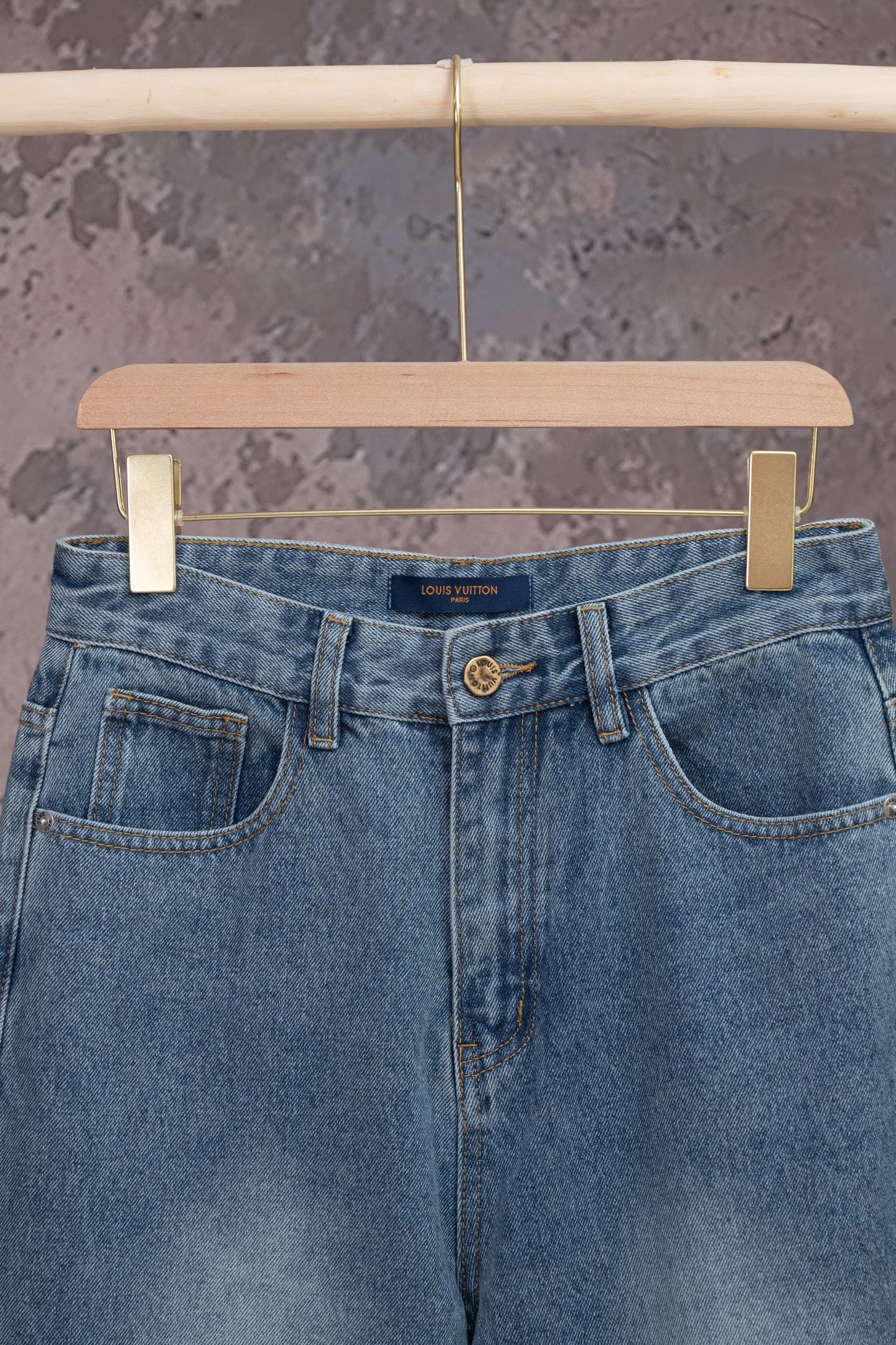 Light blue denim jeans with belt loops, front button, and dual front pockets