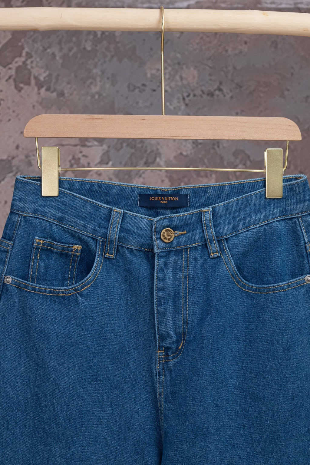 Louis Vuitton blue denim pants, close-up of waistband and button