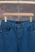 Louis Vuitton blue denim pants, close-up of waistband and button