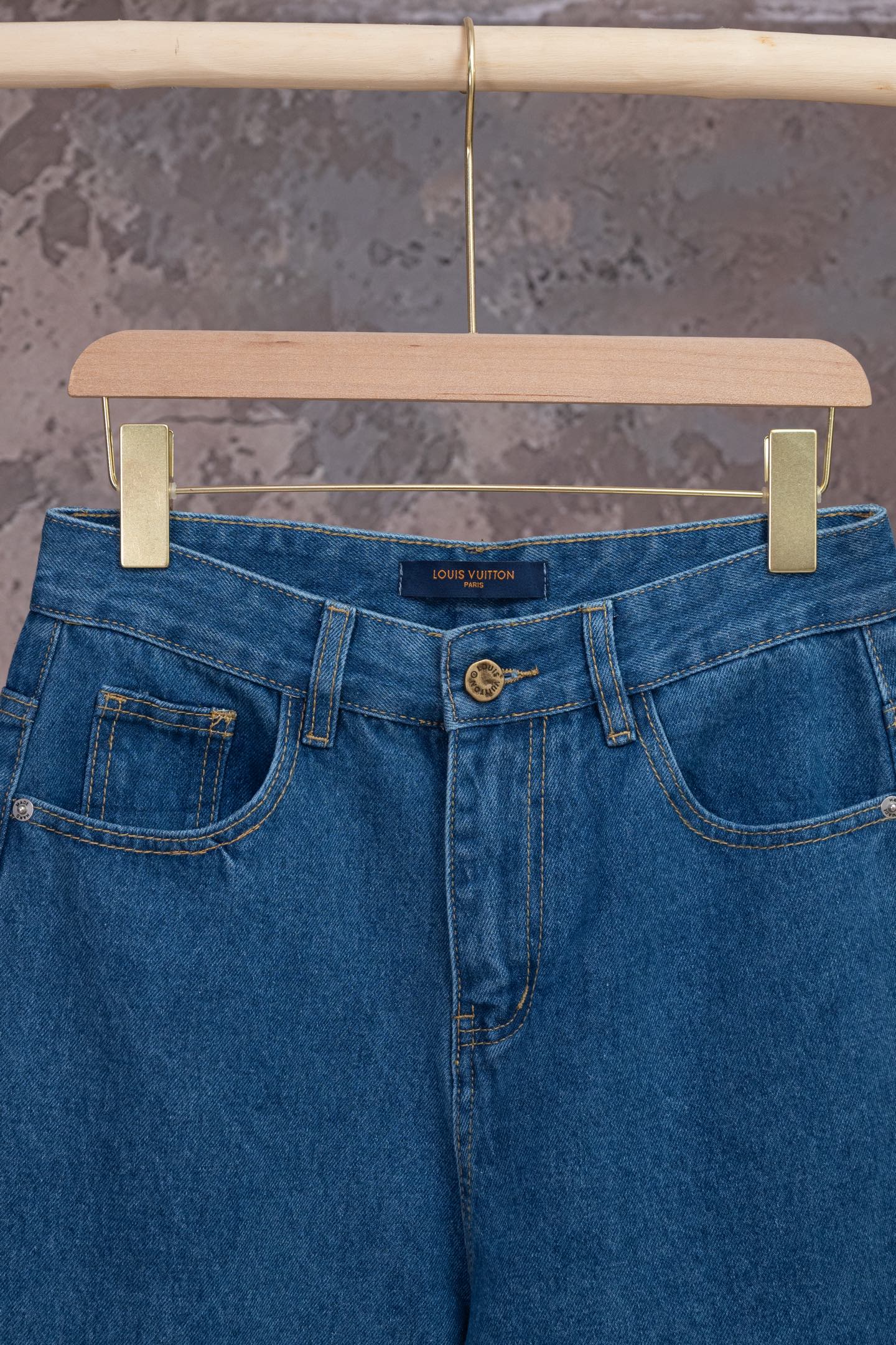 Louis Vuitton blue denim pants, close-up of waistband and button