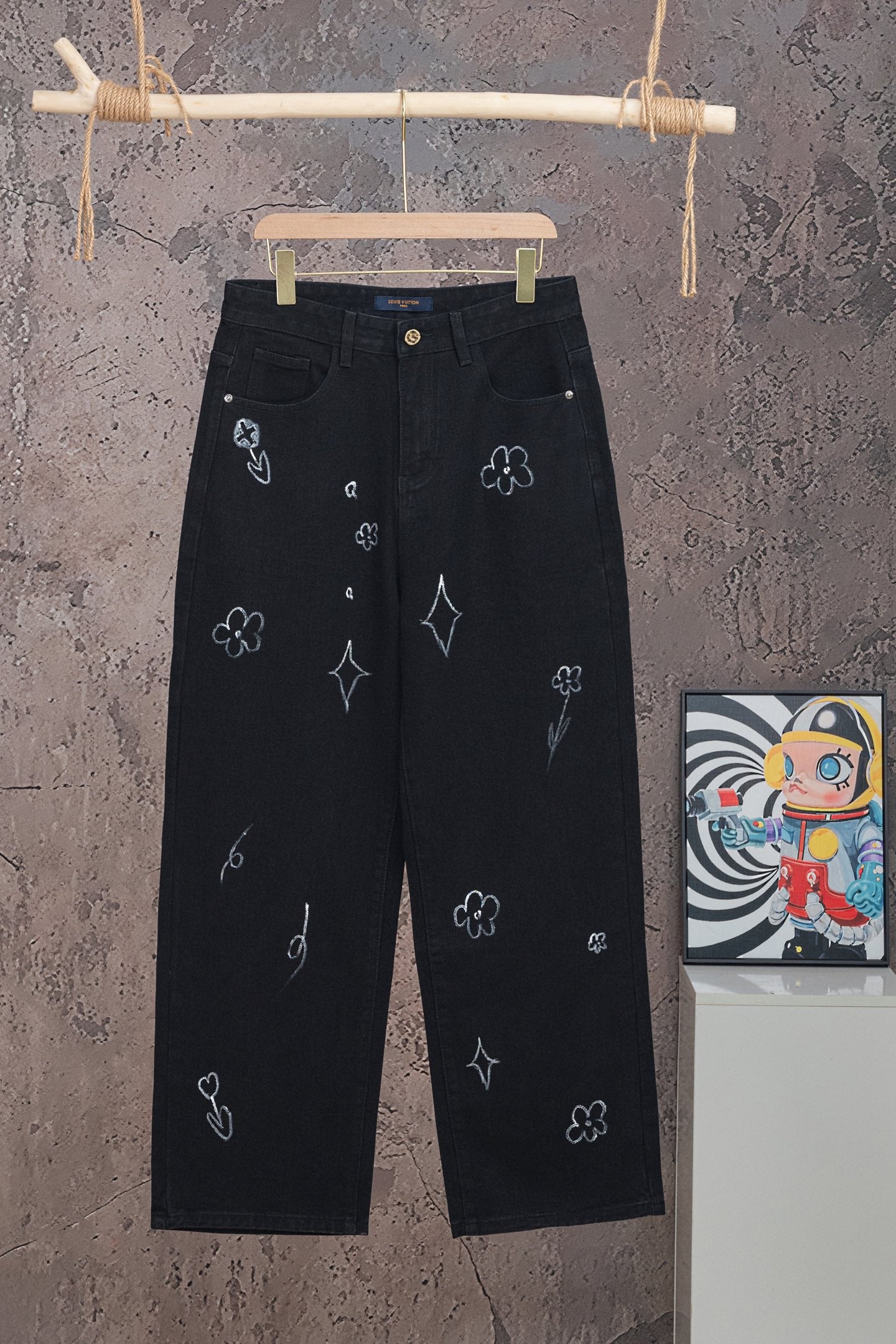 Black Louis Vuitton pants with embroidered icons and button closure