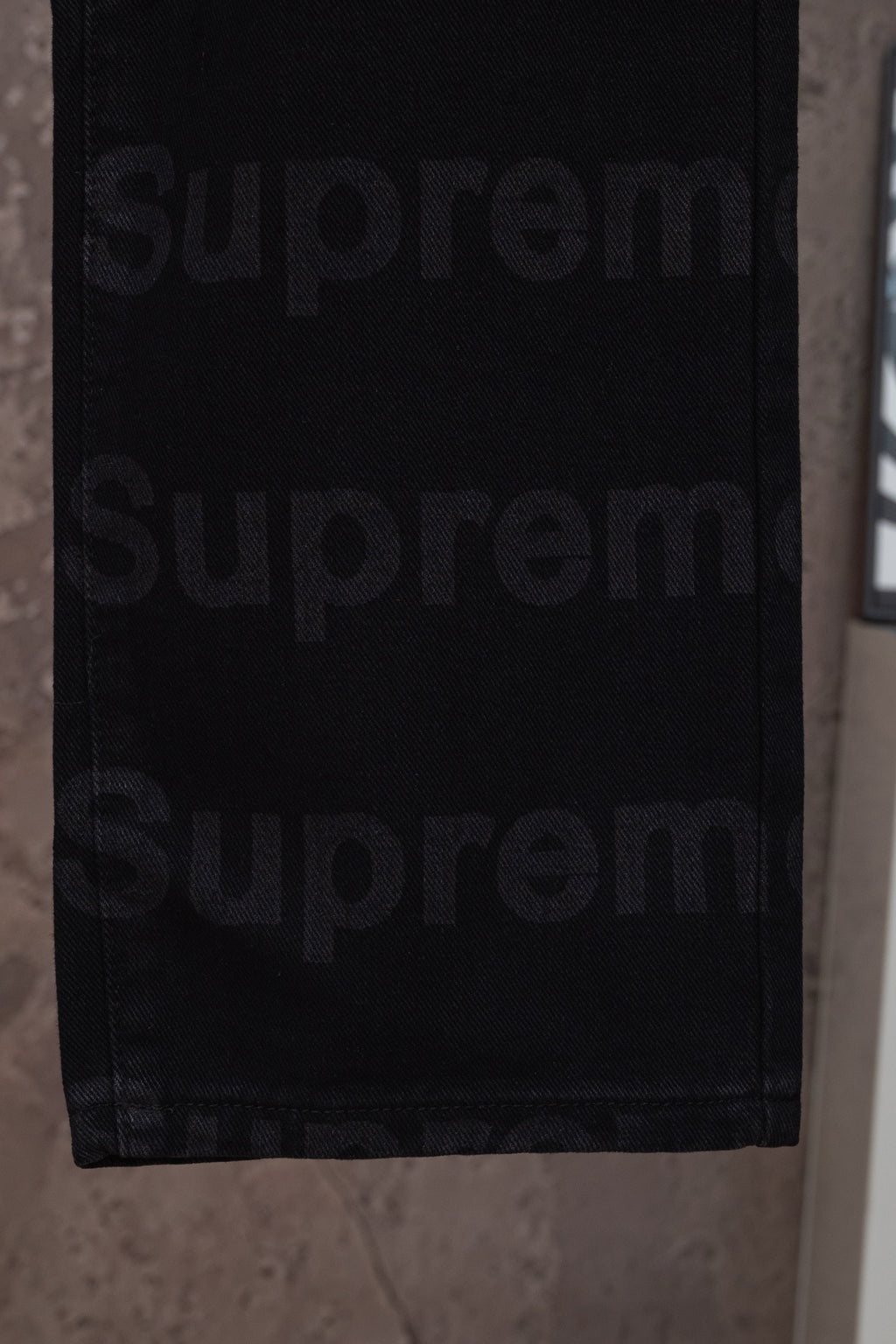 Black denim pants hem and lower leg close-up