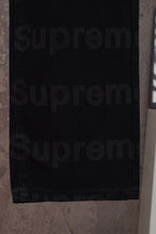 Black denim pants hem and lower leg close-up