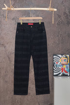 Black denim pants on hangers with red Supreme waistband label