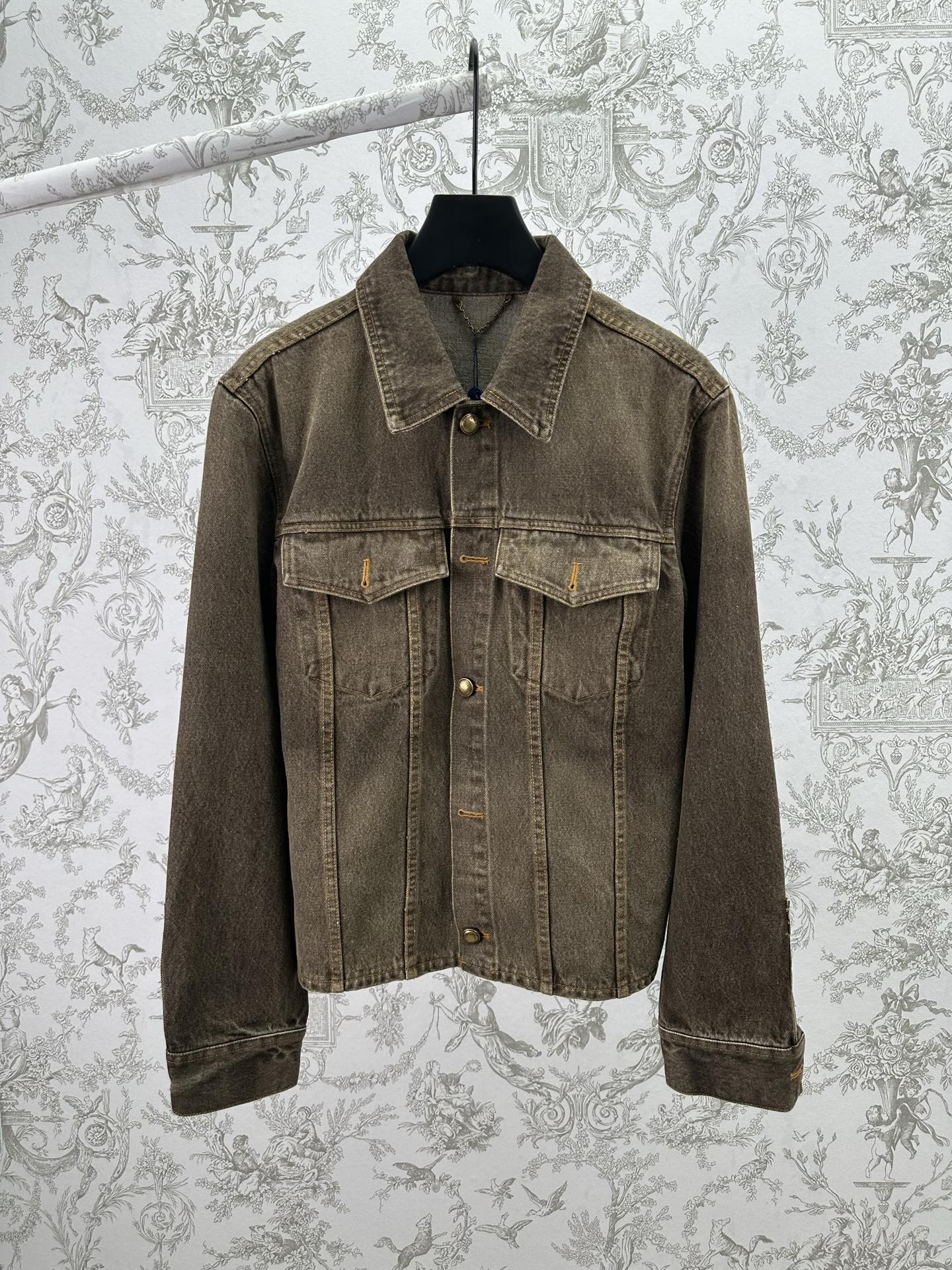 Dark gray denim jacket with button-up front and flap chest pockets, long sleeves