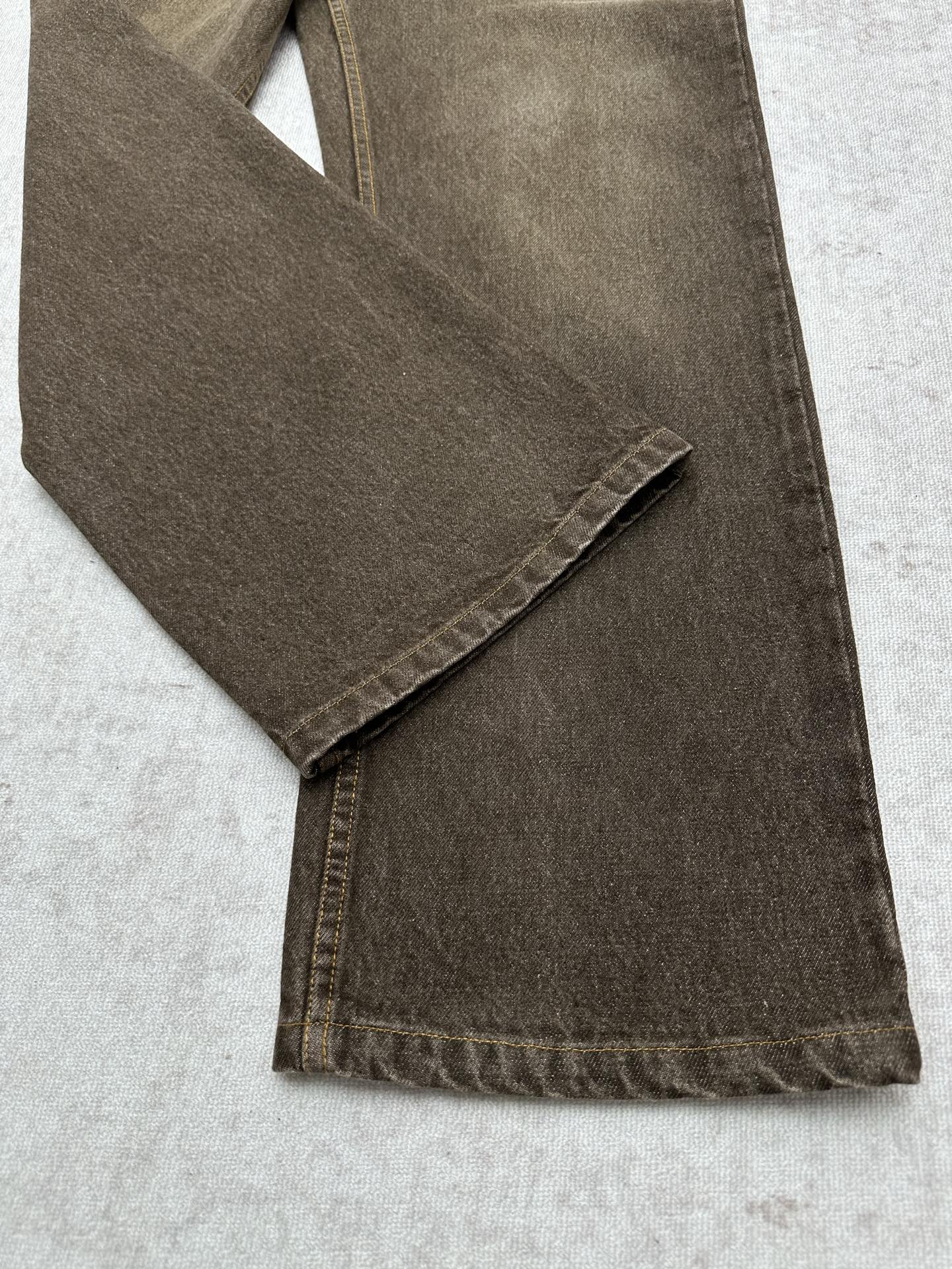 Brown denim jeans folded detail with stitched hem and side seam