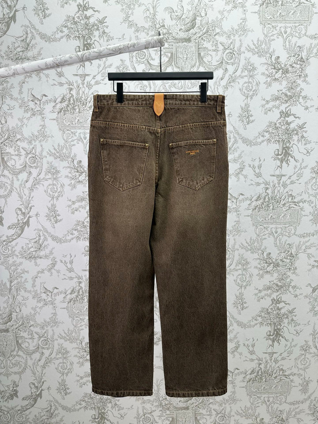 Brown denim jeans, back view with two patch pockets and belt loops