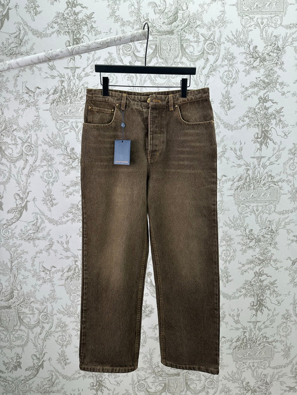 Brown denim jeans, straight-leg cut with front button closure and belt loops