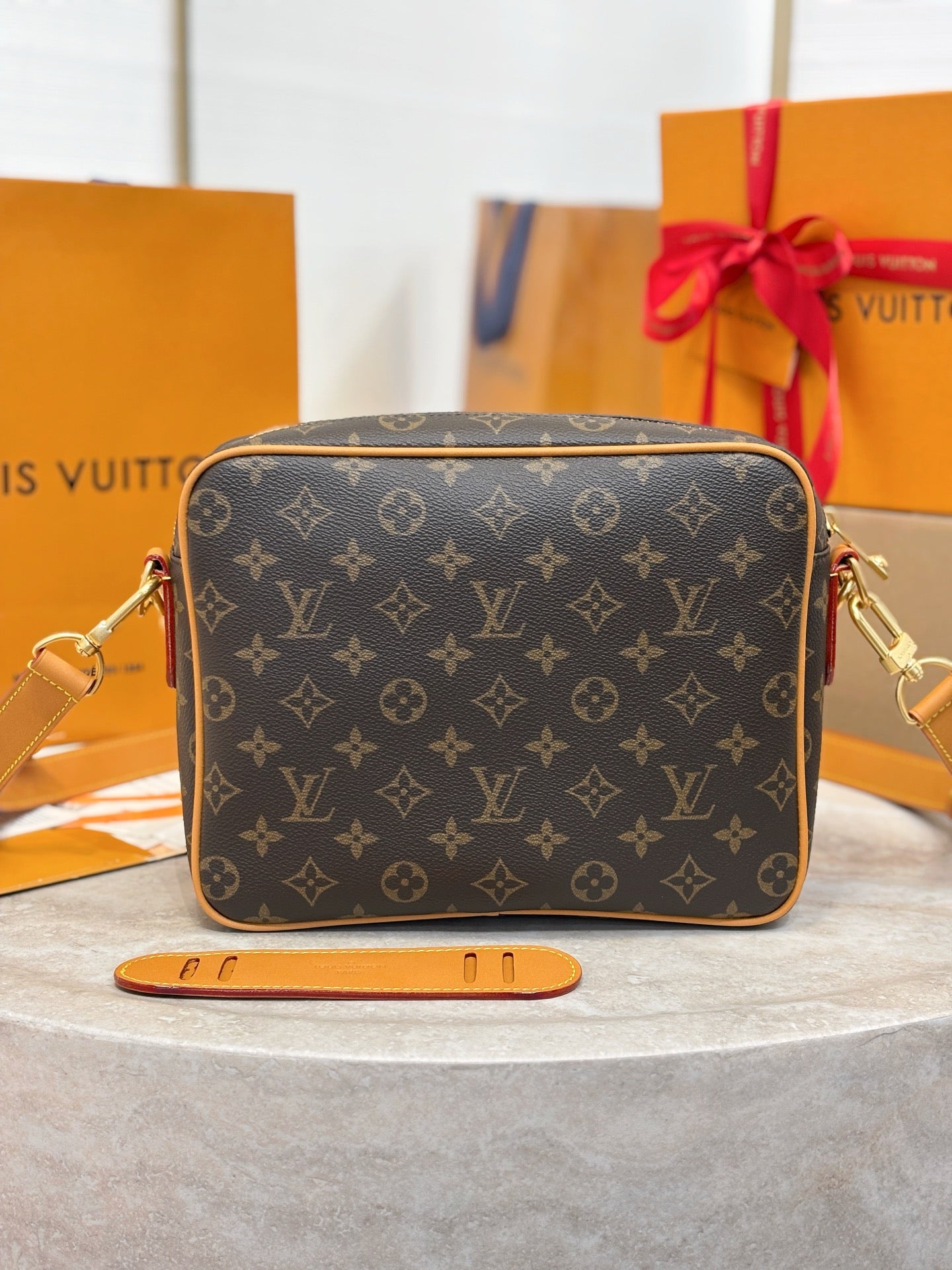 Louis Vuitton crossbody bag, monogram canvas exterior with tan edges and gold hardware