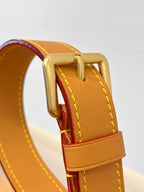 Tan leather strap and gold ring on Louis Vuitton monogram bag with red accent stitching