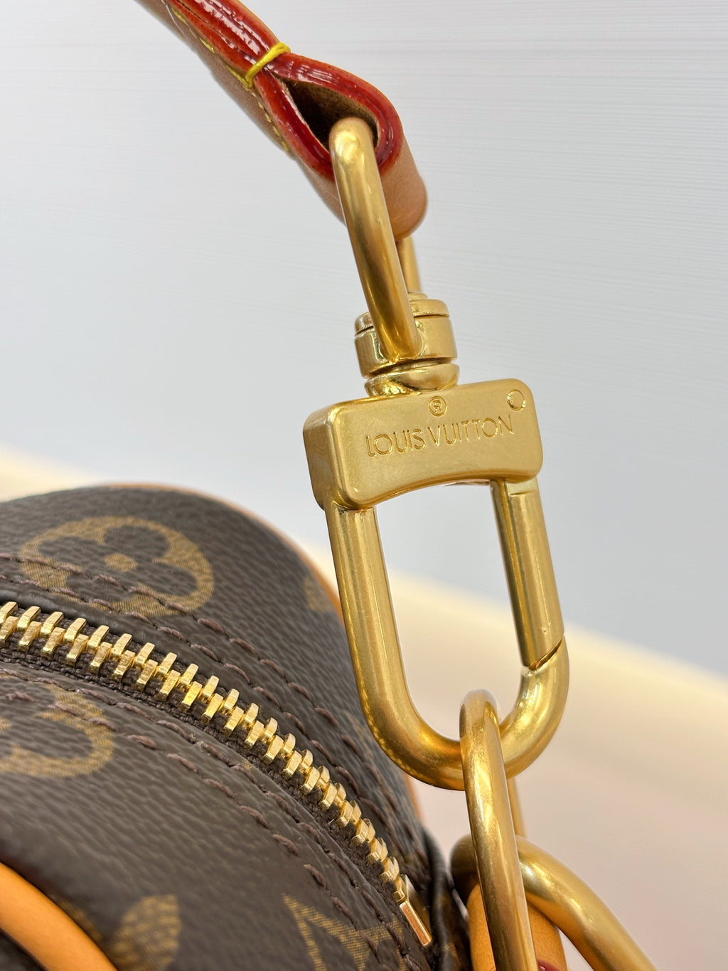 Louis Vuitton gold clasp hook on monogram crossbody bag with chain strap