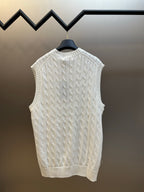 White cable-knit sweater vest with V-neck and ribbed neckline