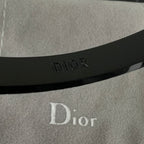 Black cuff bracelet with Dior logo embossed on the inner band