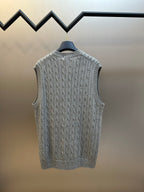 Gray cable-knit sleeveless sweater vest on hanger with ribbed hem