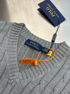 Gray cable-knit sweater vest neckline with Polo logo and orange hanger