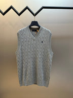 Gray cable-knit sweater vest with V-neck and sleeveless design