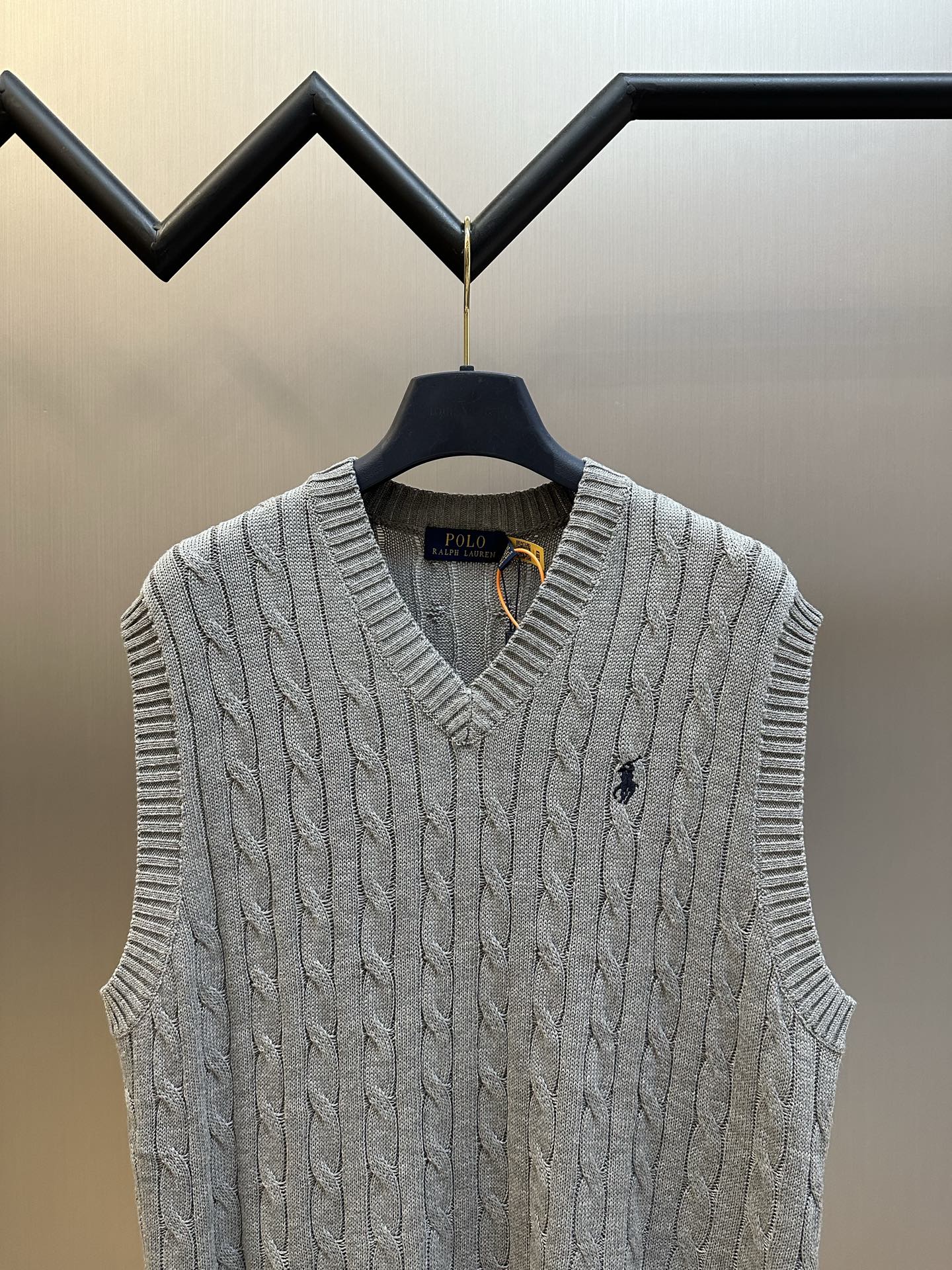 Gray cable-knit sweater vest with V-neck and small Polo logo