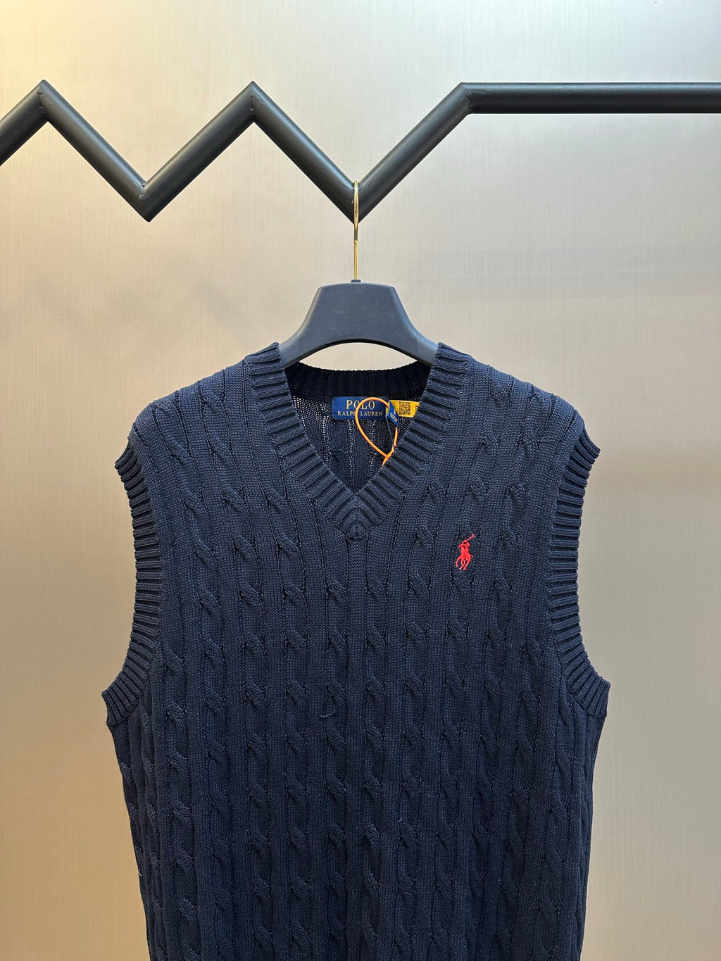 Navy sleeveless cable-knit sweater vest with V-neck and Polo logo on chest