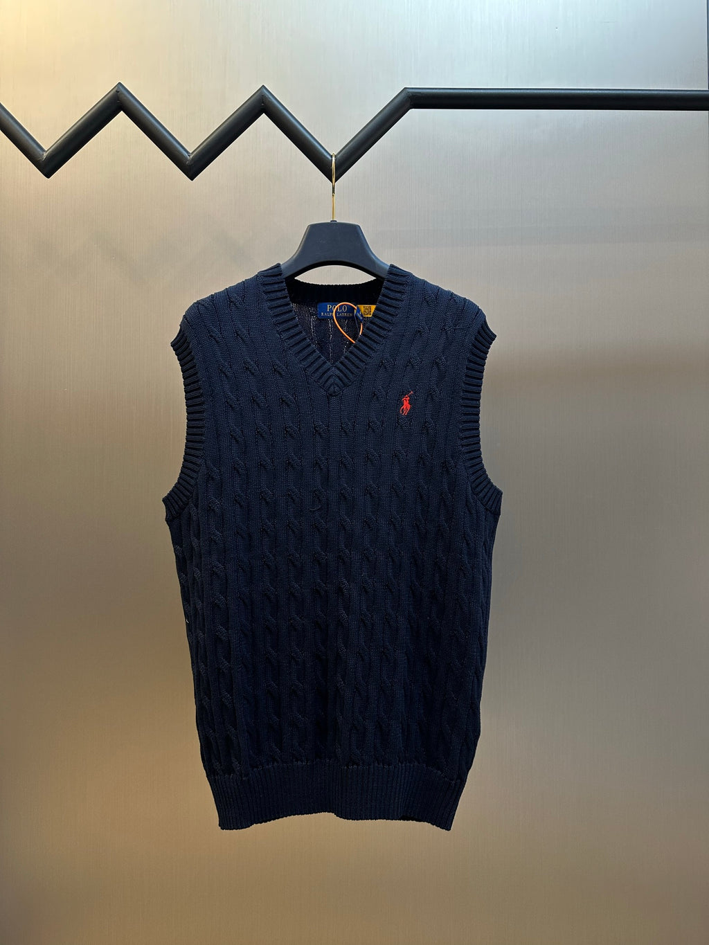 Navy knit sleeveless sweater vest with V-neck and small red Polo logo