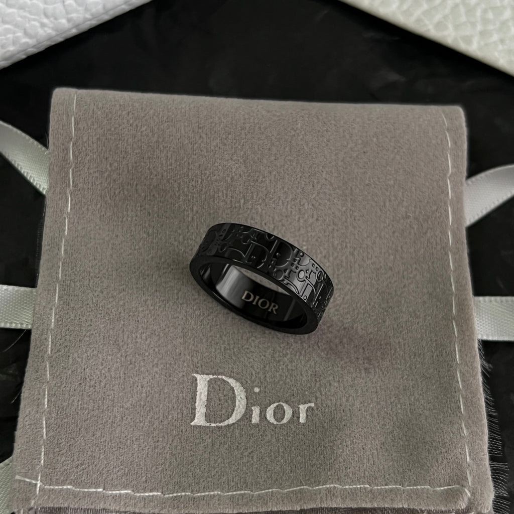 Black Dior logo ring resting in a gray gift box