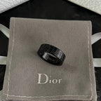 Black Dior logo ring resting in a gray gift box