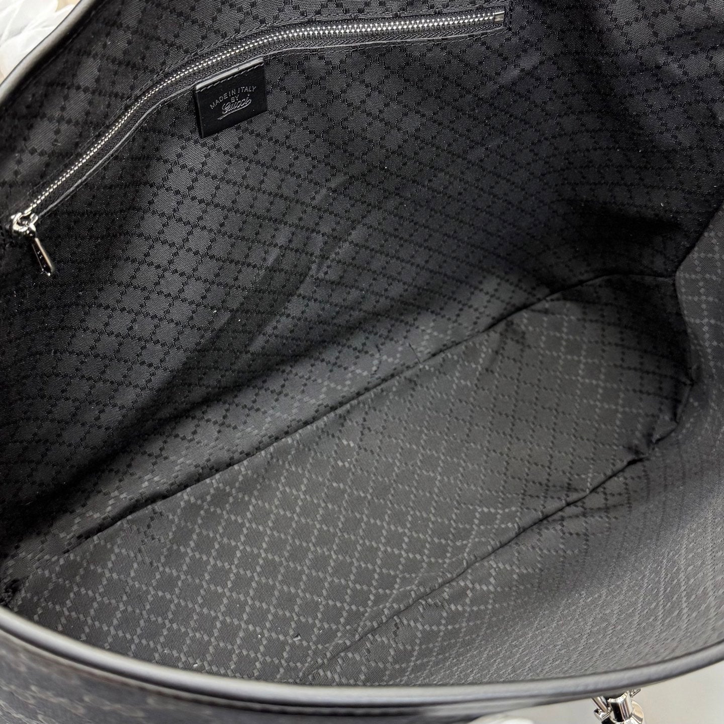 Gucci tote bag interior with dark fabric lining and stitched bottom seam