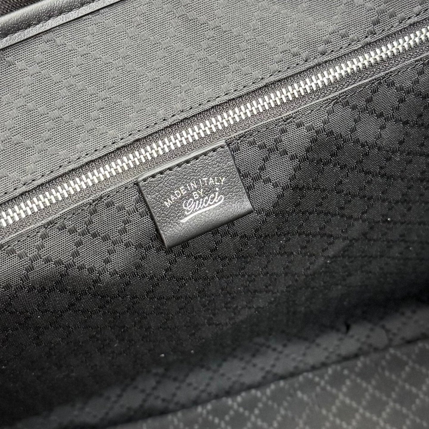 Gucci tote bag close-up of inside pocket label with zip and GG monogram lining
