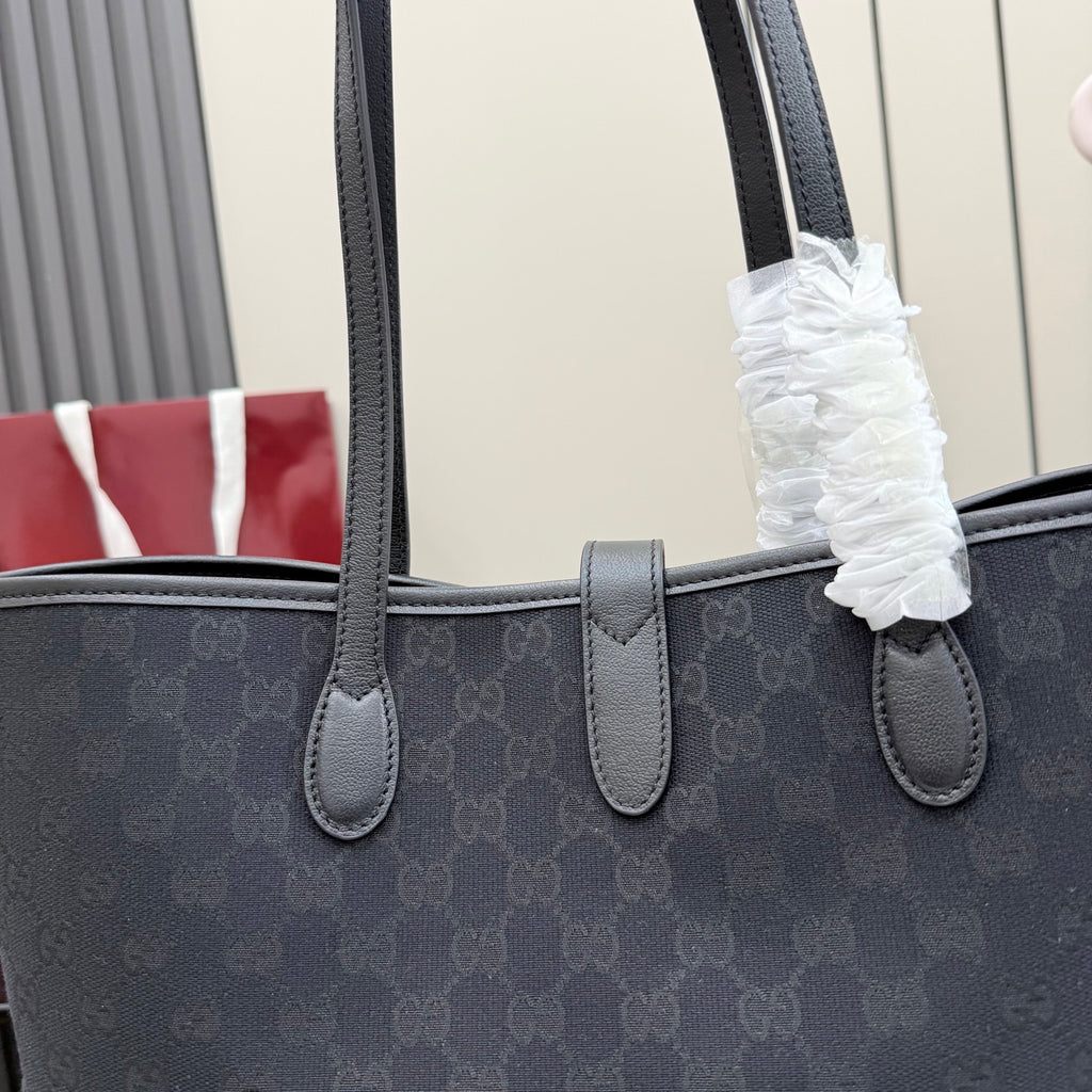 Gucci tote bag close-up of front strap attachments on dark GG monogram canvas
