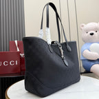 Gucci tote bag in dark GG monogram canvas with leather handles and hanging key charm