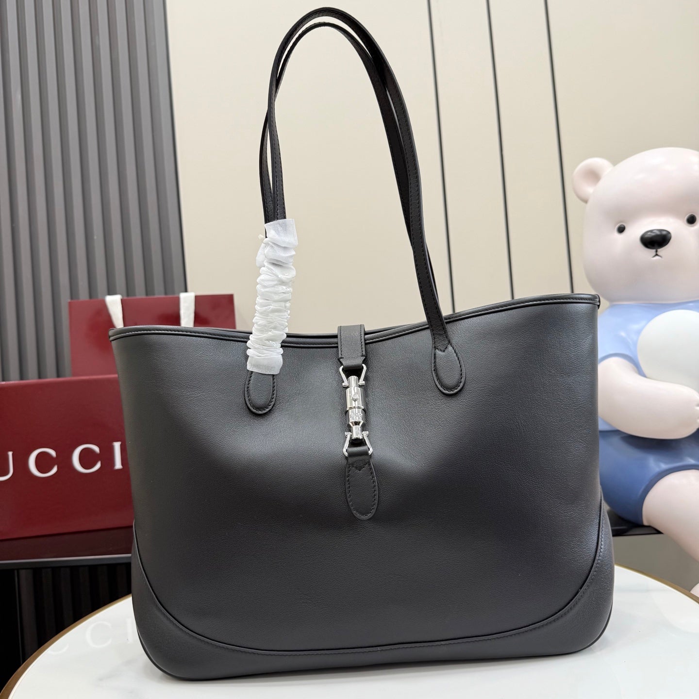 Gucci black leather tote bag with top handles and front clasp hardware