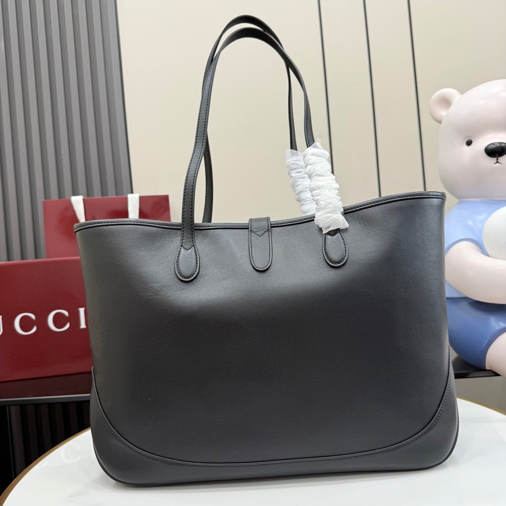 Gucci black leather tote bag with dual top handles and front closure hardware