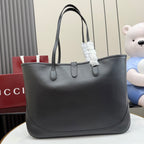 Gucci black leather tote bag with dual top handles and front closure hardware