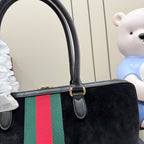 Gucci bag close-up of top handle and green-red-green stripe on black body