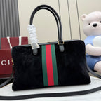 Gucci bag with black top handles and green-red-green stripe front panel