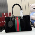 Gucci bag with black top handles, green-red-green stripe, and gold-tone hardware