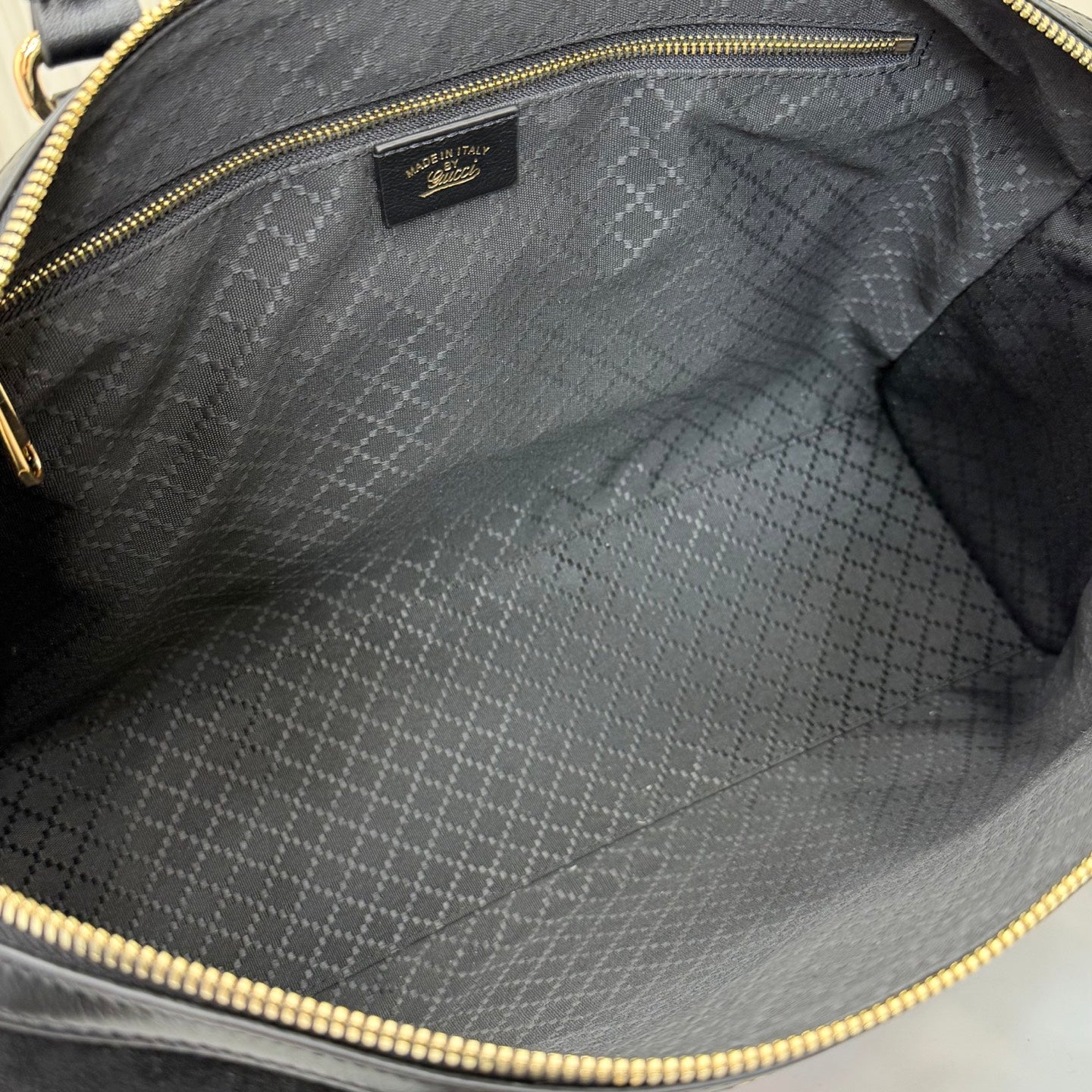 Gucci bag interior with gray jacquard lining and zipper opening