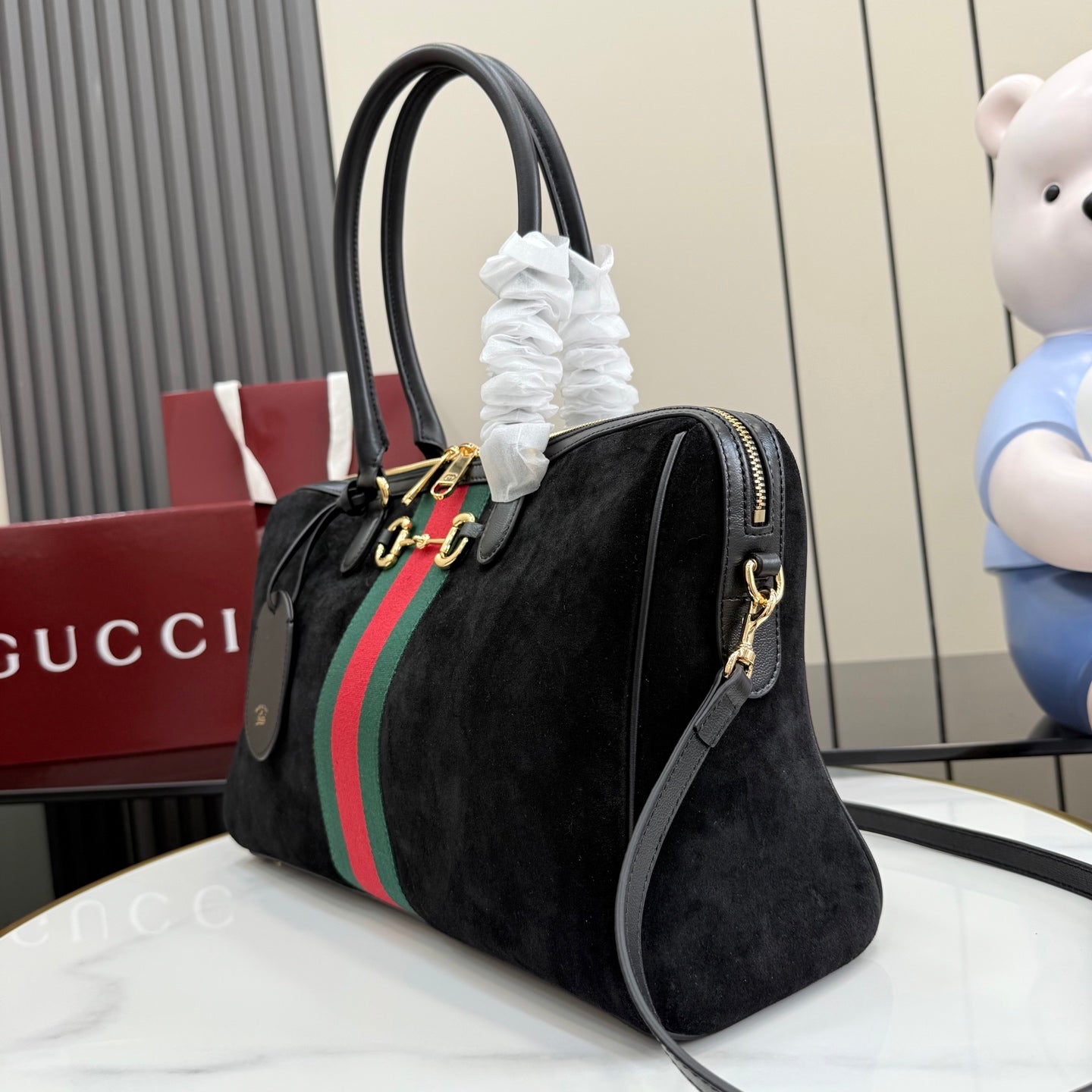 Gucci bag with short black handles, green-red-green stripe, and crossbody strap