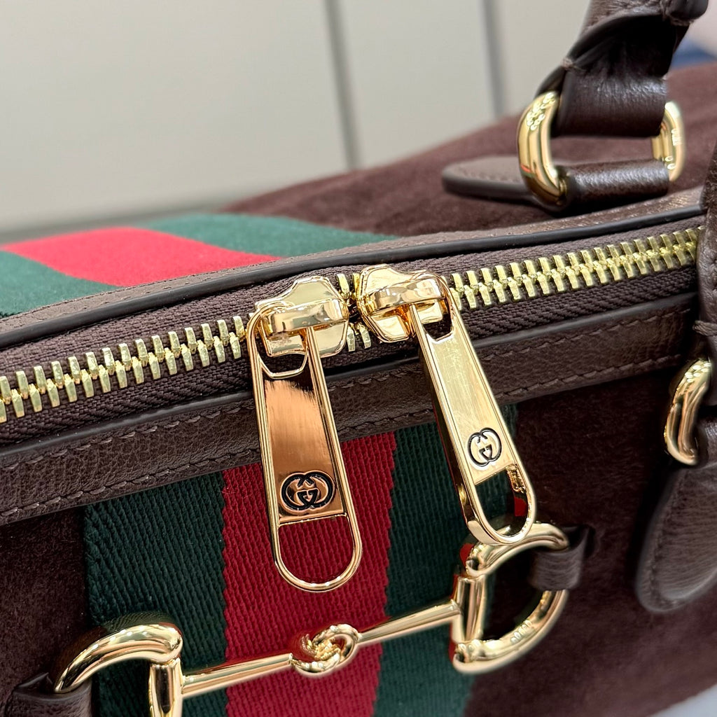 Gucci handbag zipper and gold-tone hardware with green and red web stripe detail