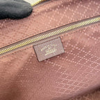Gucci handbag interior pocket with textured light pink fabric and logo label