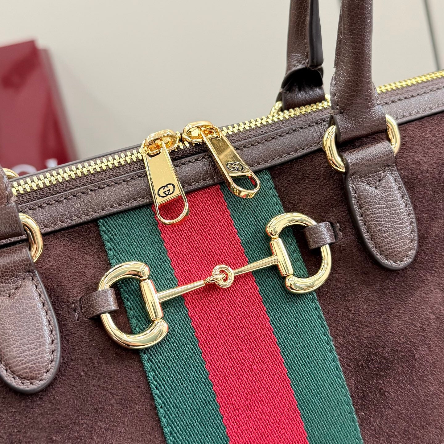 Gucci handbag hardware on dark brown leather with green and red web stripe