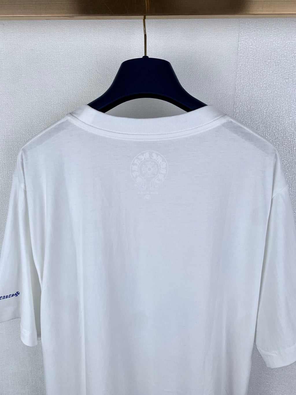 White short-sleeve T-shirt back view with small center emblem