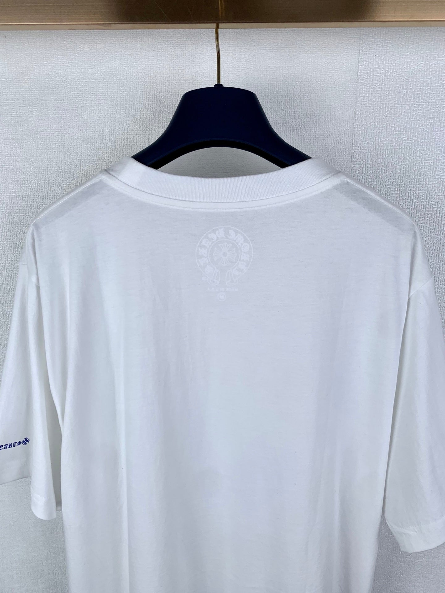 White short-sleeve T-shirt back view with small center emblem