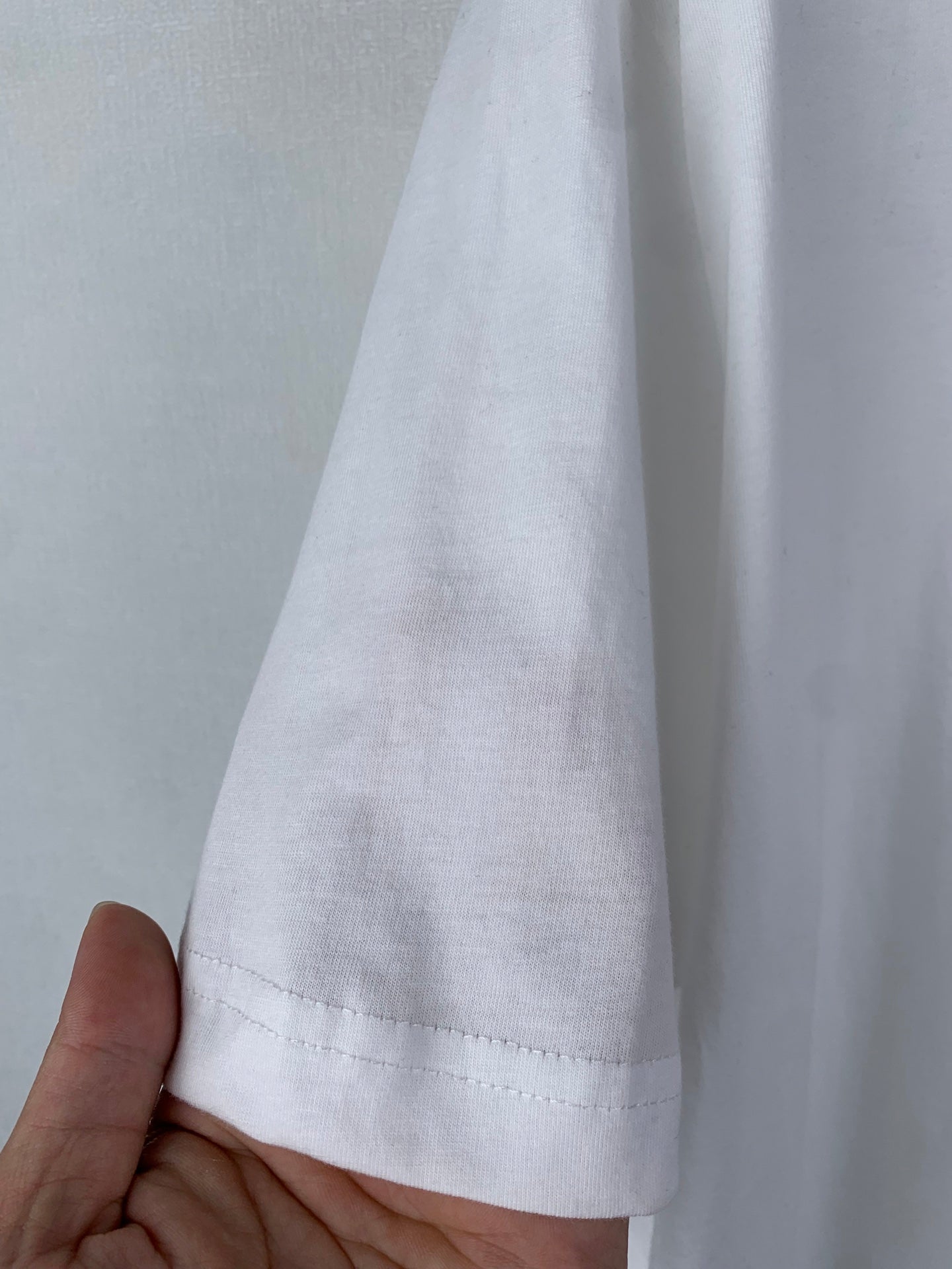 White T-shirt sleeve hem with visible stitching