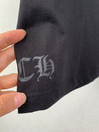 Black T-shirt fabric with gray printed symbol on sleeve