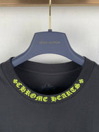 Black crew-neck T-shirt close-up with neon green graphic text at neckline
